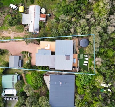 Spacious property surrounded by greenery, featuring ample outdoor space and convenient access to main roads.