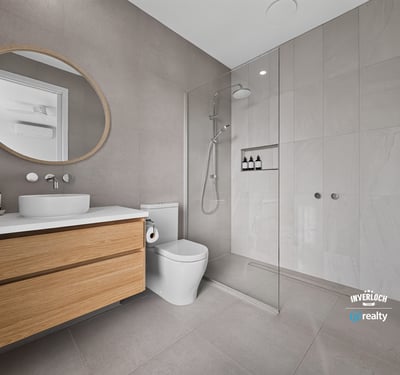 Modern bathroom featuring a spacious walk-in shower, sleek cabinetry, and contemporary finishes throughout.