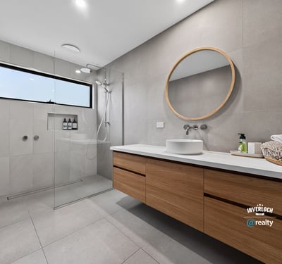This modern bathroom features a spacious design, sleek finishes, and natural light from a large window.