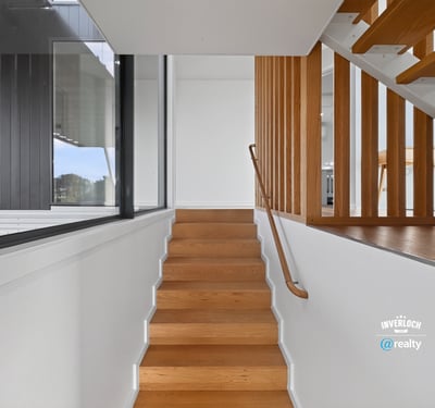 Modern staircase featuring sleek lines and natural light, seamlessly connecting spaces in a contemporary home.