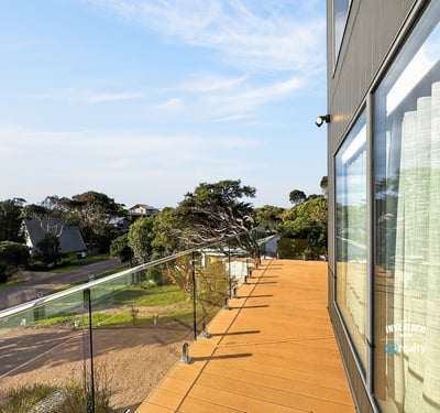 Contemporary outdoor space offers panoramic views, ideal for relaxation or entertaining in a coastal setting.
