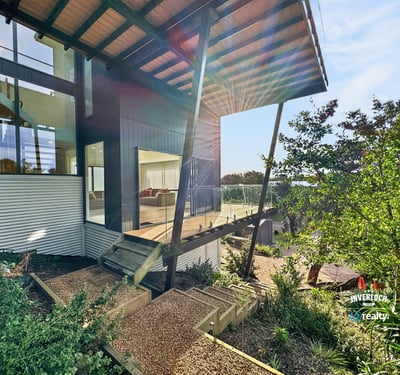Modern architectural design features expansive outdoor views and vibrant landscaping for a unique living experience.