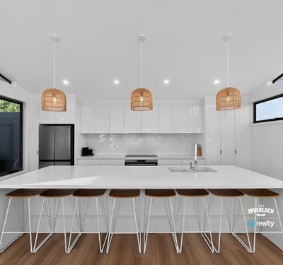 Bright and airy kitchen featuring modern finishes, ample counter space, and inviting seating for gatherings.