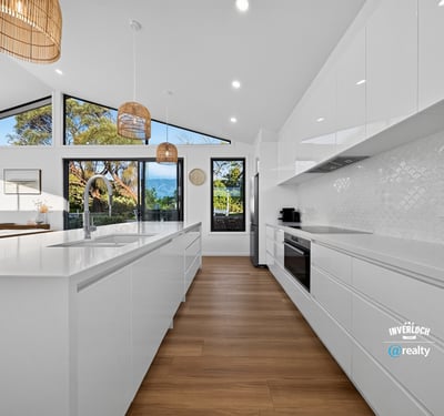 Modern kitchen featuring sleek cabinetry, ample natural light, and scenic views, perfect for culinary enthusiasts.