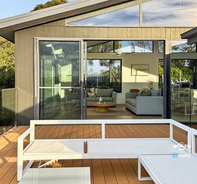 Modern home featuring a spacious deck with expansive views, seamlessly connecting indoor and outdoor living areas.