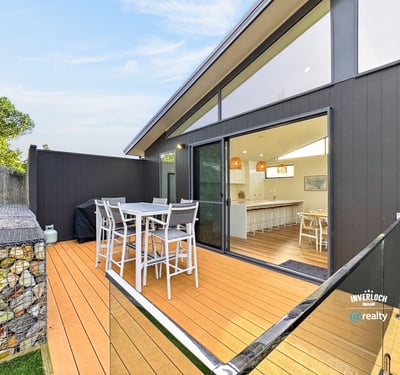 Spacious outdoor deck seamlessly connects to an airy indoor living space, perfect for entertaining and relaxation.