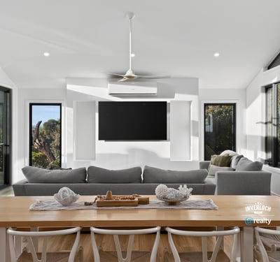 Bright, open-plan living area with panoramic views, featuring large windows and a modern, minimalist design.