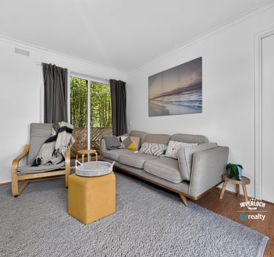 Bright and inviting living space featuring large windows, modern furnishings, and a seamless connection to outdoor views.