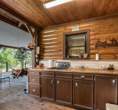 Enjoy rustic charm in this inviting kitchen space, perfect for entertaining on the covered patio.