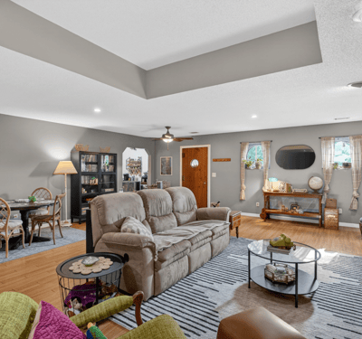 Spacious living area features modern decor, ample natural light, and versatile seating for relaxation or gatherings.