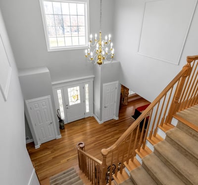 Gleaming hardwood flooring, custom moldings, display shelves, and natural light.
