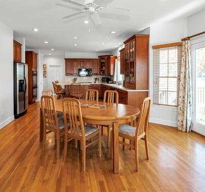 Kitchen dining area features a ceiling fan, French doors to the deck and patio, and morning sun and sunrise views.