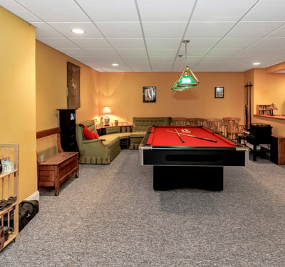 The lower-level Game Room is a wonderful space to enjoy a round of pool or relax and listen to music.