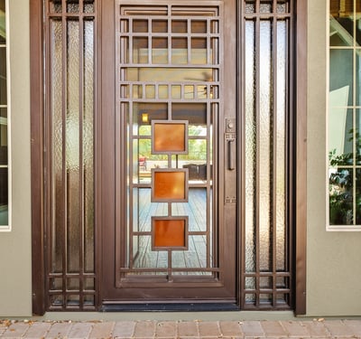 This custom iron front door makes a bold architectural statement while enhancing security and natural light, setting the tone for the craftsmanship found throughout the home.