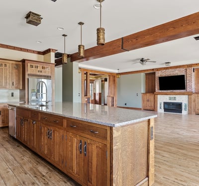 Wide open kitchen and living area showcasing wood beams, cohesive finishes, and generous square footage. A hallmark of this Phoenix home s thoughtful open concept design.