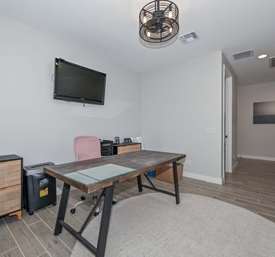 Tucked away for quiet productivity, this smartly designed den offers comfort and style with recessed lighting and modern finishes.