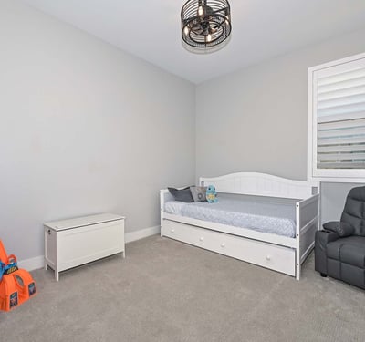 A bright and neutral bedroom with playful touches and room to grow. Use it as a nursery, guest space, or stylish home office.