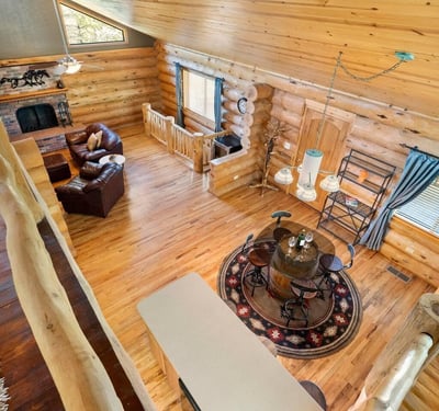 Overlook from the loft capturing the open-concept design, vaulted ceilings, and natural wood finishes that define this custom Prescott home.