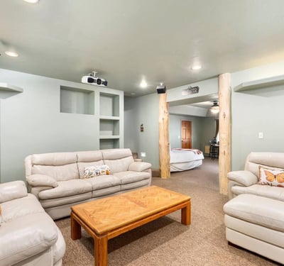 Lower-level living space with built-ins and open layout, ideal for lounging, hobbies, or overflow entertaining.