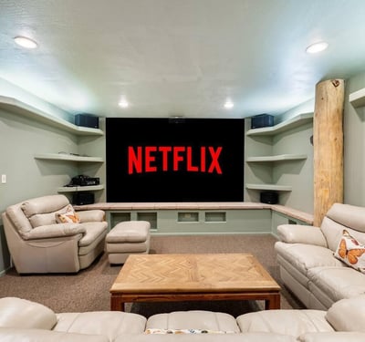 Entertainment-focused theater room with projector screen, built-in shelving, and surround-style setup for immersive movie nights.
