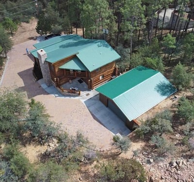 Aerial view capturing the home s layout and wooded surroundings. This perspective highlights privacy, generous outdoor space, and the peaceful setting found in this Prescott retreat.