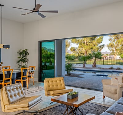 Expansive sliding glass doors connect the living room to the covered patio, showcasing seamless Scottsdale living.