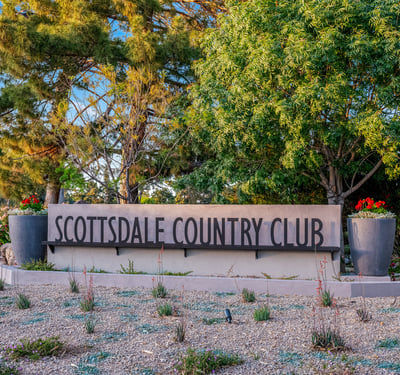 Beautifully landscaped entry to Scottsdale Country Club, offering golf, fitness, and community amenities for a resort-style lifestyle.