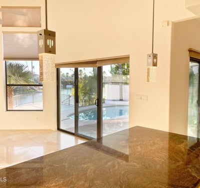 Contemporary kitchen island illuminated by elegant pendant lights, offering abundant space for meal prep and casual dining.