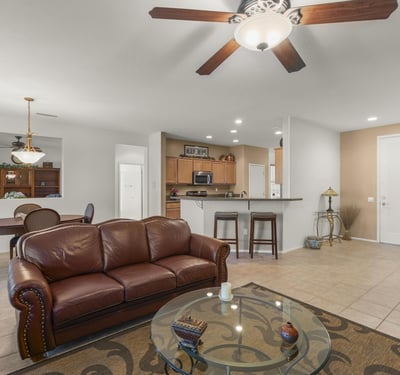 The open great room showcases tile flooring, neutral colors, and recessed lighting. Ideal for entertaining, it seamlessly connects to dining and kitchen spaces.