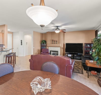 A beautiful dining area opens effortlessly to the living room and kitchen. Elegant lighting and tile floors enhance its bright, open ambiance.