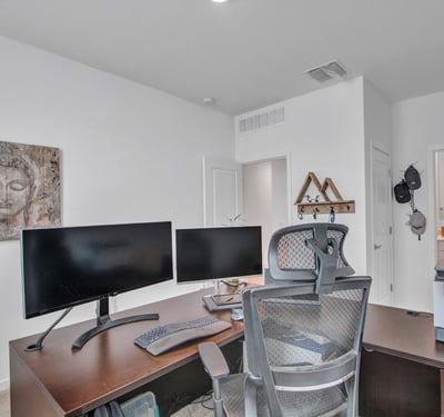 This dedicated office setup demonstrates the room s flexibility, ideal for remote work or creative space. Energy-efficient windows support comfort and productivity in this Litchfield Park home.