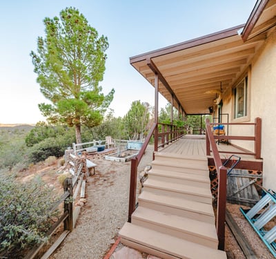Highlighted by exposed beams and rich wood textures, this great room creates a welcoming retreat. Expansive windows bring in mountain views and natural light, reinforcing the home s seamless connection to Hackberry s peaceful environment.