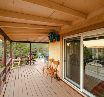 This bright dining area is surrounded by windows capturing desert greenery and garden views. A perfect everyday retreat, it elevates the home s warm, inviting atmosphere with abundant natural light.