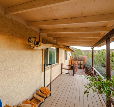 A charming porch lined with natural wood accents connects seamlessly to pathways and surrounding trees. Perfect for enjoying Hackberry s peaceful outdoor lifestyle.
