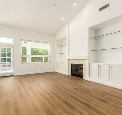 Comfortable family room with a stylish fireplace and built-in shelving accents. This inviting Scottsdale space is perfect for relaxing evenings or entertaining guests in a warm, welcoming setting.