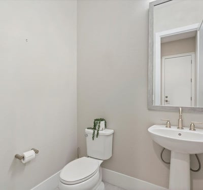 Guest powder bathroom with pedestal sink and stylish finishes, conveniently located for visitors and daily use.