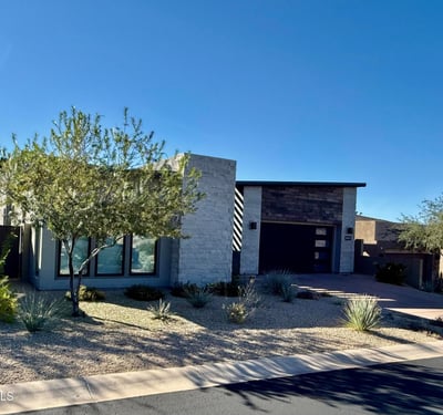 Front exterior highlighting contemporary architecture, desert landscaping, and clean modern lines in a prestigious Scottsdale neighborhood.