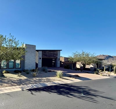 Front-of-home view emphasizing the home s refined architecture, stone finishes, and low-maintenance landscaping in North Scottsdale.