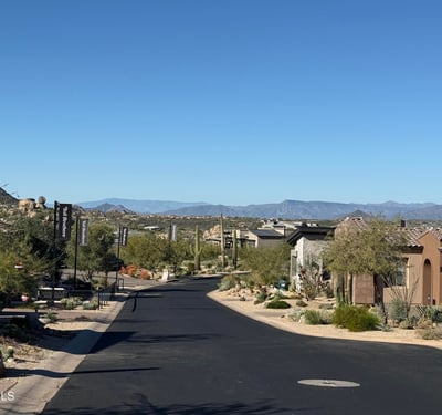 View of the neighborhood streetscape highlighting clean asphalt roads, contemporary desert architecture, and scenic mountain backdrops that define this refined Scottsdale community lifestyle.
