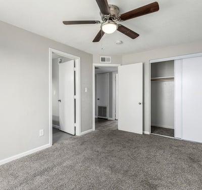 Primary bedroom view with ample space, soft carpet, and direct access to the ensuite bathroom designed for everyday convenience in this Phoenix home for sale.