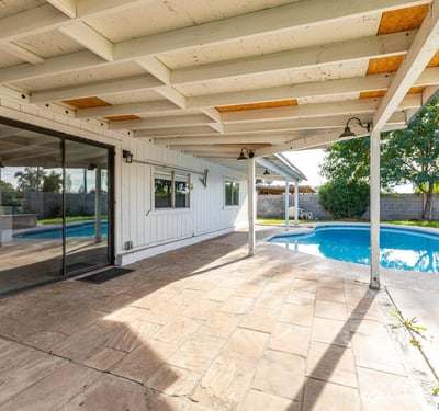 Backyard overview featuring a private pool, covered patio, and open space for lounging or play perfect for enjoying the Phoenix lifestyle and entertaining year-round.