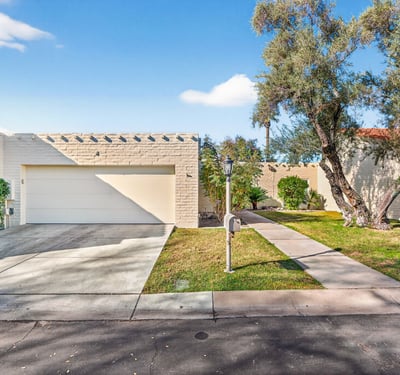 Well-maintained Phoenix exterior with attached garage, private walkway, and secure guard-gated access for peace of mind.