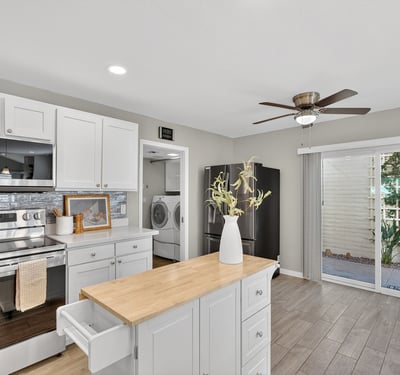 Functional kitchen with island workspace, modern finishes, and easy access to dining and living areas for seamless daily living.