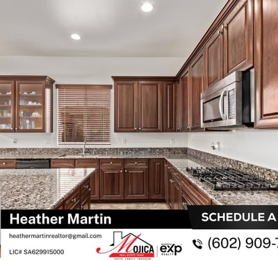 The oversized island offers seating potential and plenty of prep room. Stainless steel appliances and custom cabinetry complete the look in this beautifully maintained Glendale kitchen.