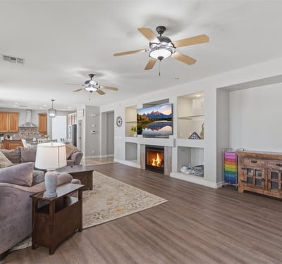 View of the large open living room connecting to the kitchen and dining areas, showcasing the modern floor plan designed for gatherings and everyday living.