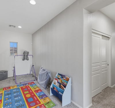 Upstairs loft and hallway connecting to bedrooms and bathrooms, providing additional living space perfect for family activities.