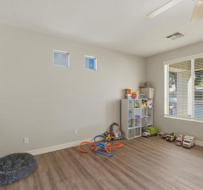 Spacious bonus room with wood-style flooring and natural light, offering flexible space for a playroom, office, or additional living area.