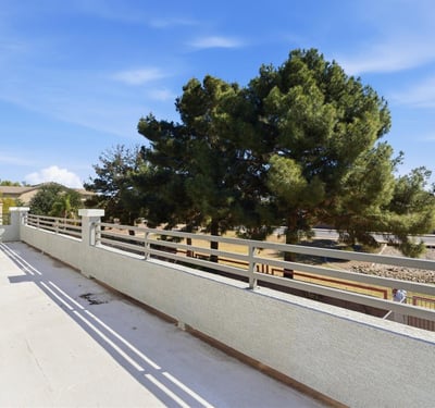 Private balcony with open views of the backyard and surrounding greenery, offering a peaceful place to enjoy fresh air and morning coffee.