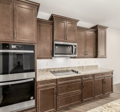 Gourmet kitchen featuring double ovens, sleek cabinetry, and premium finishes. Designed for convenience and elevated cooking experiences.