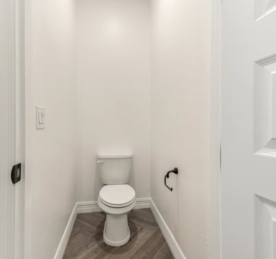 Private water closet providing additional comfort and separation within the primary bathroom.